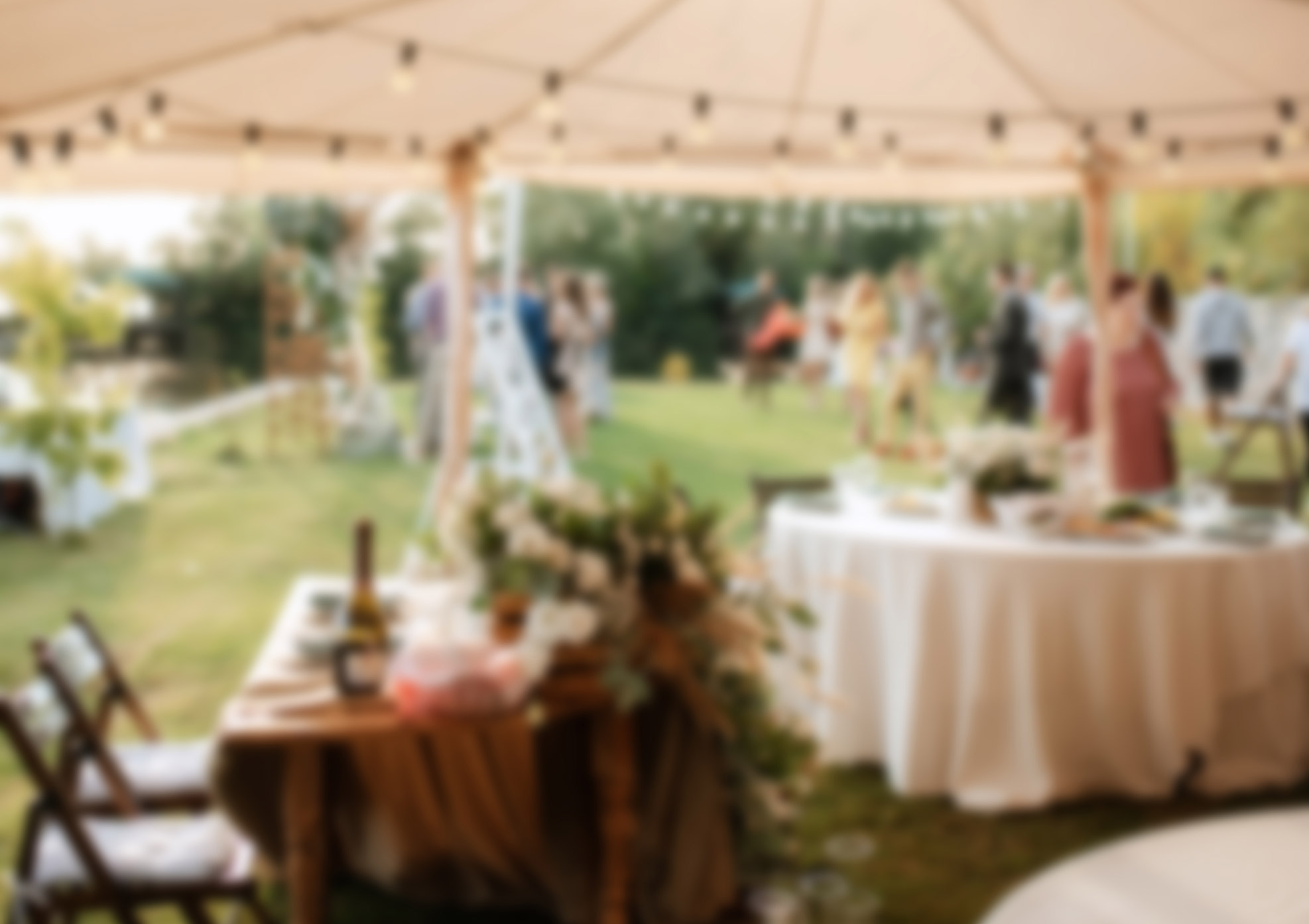 View of tables setup for event from inside marquee}